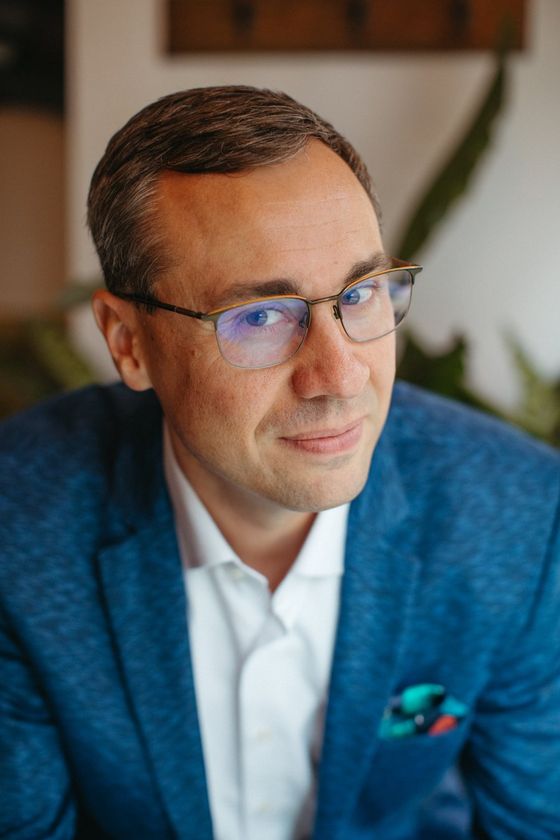 Joshua Berry smiling at the camera, in a blue jacket